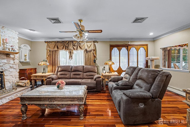 living room featuring baseboard heating, crown molding, wood finished floors, and plenty of natural light