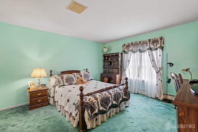 carpeted bedroom featuring baseboard heating and baseboards