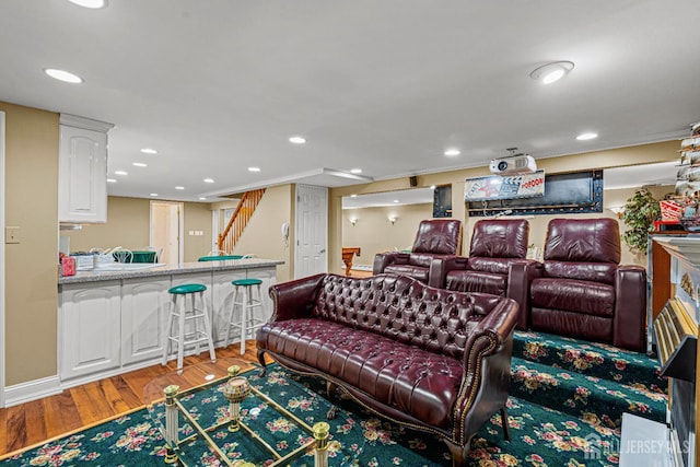 cinema with recessed lighting, light wood-style flooring, and baseboards