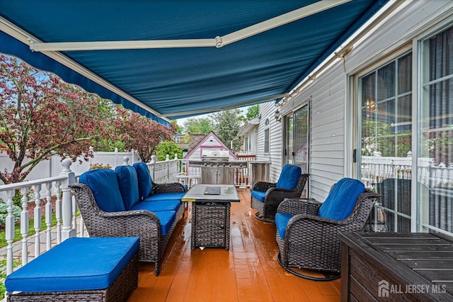 wooden terrace with an outdoor living space