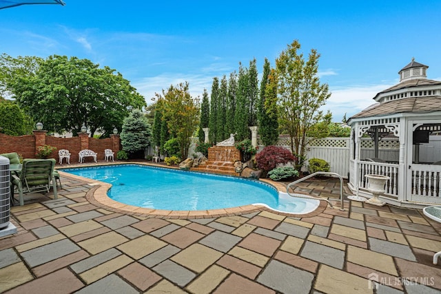 view of swimming pool featuring a gazebo, a patio, and a fenced backyard