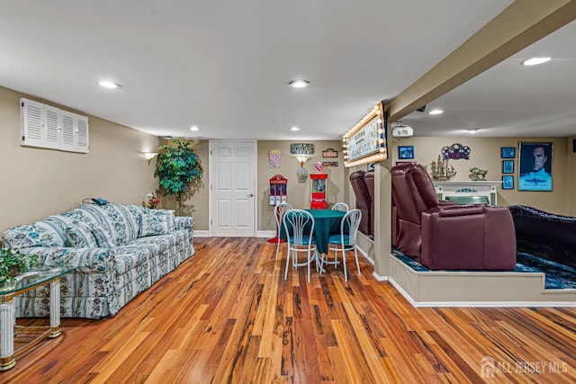 living room with wood finished floors, recessed lighting, and baseboards