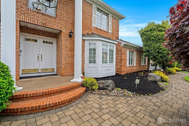 entrance to property with brick siding