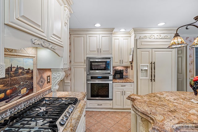 kitchen featuring stainless steel appliances, light tile patterned floors, light stone counters, pendant lighting, and decorative backsplash