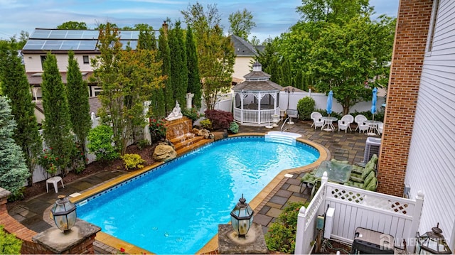 view of pool with a gazebo, a patio, and a fenced backyard