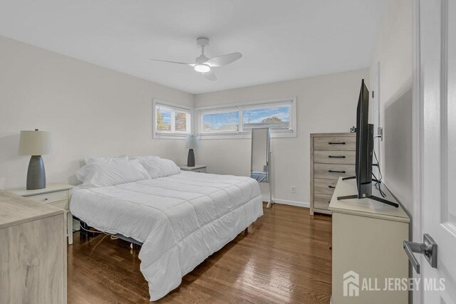 bedroom with wood-type flooring and ceiling fan