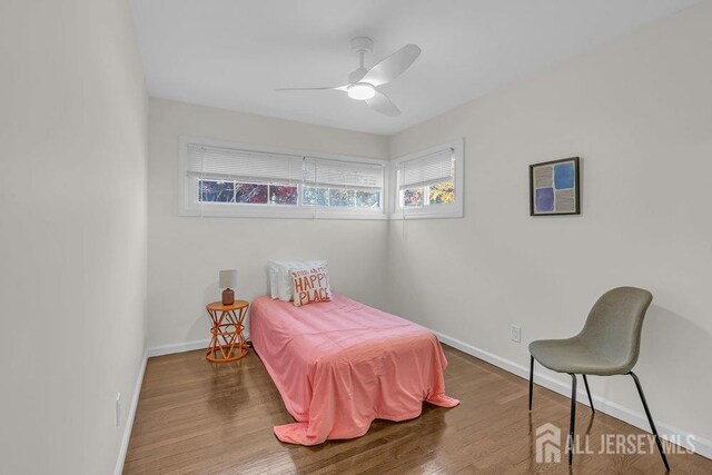 bedroom with ceiling fan and wood-type flooring