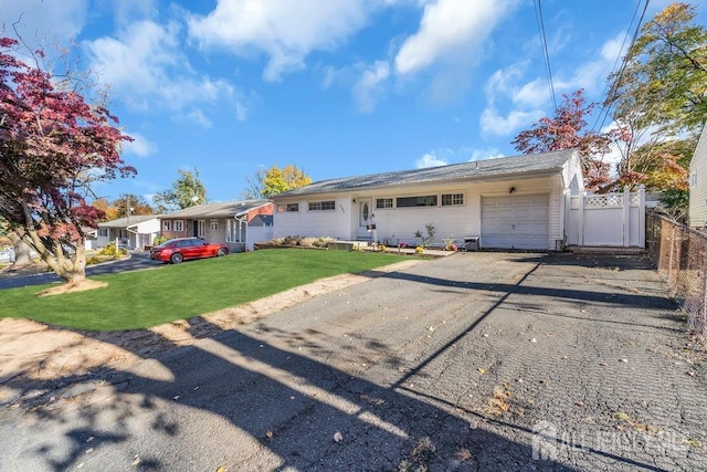 single story home with a garage and a front yard