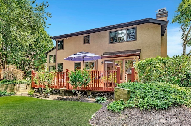 107 Sayre Dr, Plainsboro, NJ 08540 - back of property featuring stucco siding, a wooden deck, a chimney, and a yard