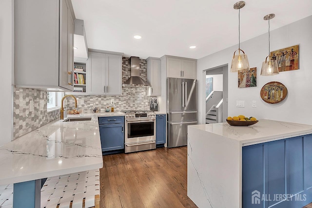 107 Sayre Dr, Plainsboro, NJ 08540 - kitchen with appliances with stainless steel finishes, wall chimney exhaust hood, light stone counters, backsplash, and dark wood-style flooring