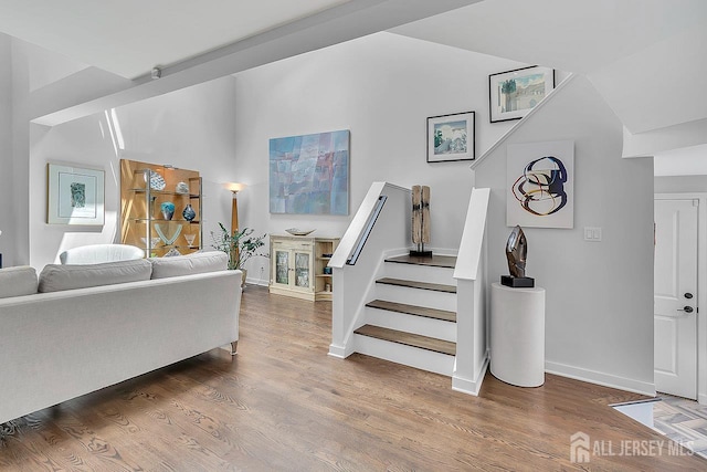 107 Sayre Dr, Plainsboro, NJ 08540 - living area with stairs, wood finished floors, and high vaulted ceiling