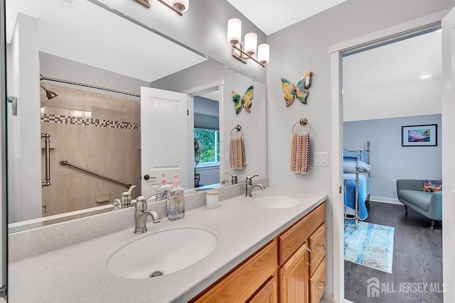 107 Sayre Dr, Plainsboro, NJ 08540 - ensuite bathroom featuring double vanity, wood finished floors, and tiled shower