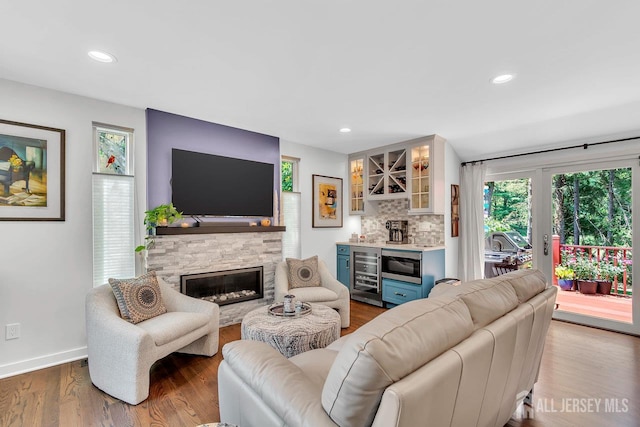 107 Sayre Dr, Plainsboro, NJ 08540 - living area featuring a bar, wine cooler, wood finished floors, a fireplace, and recessed lighting