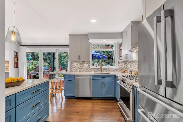 107 Sayre Dr, Plainsboro, NJ 08540 - kitchen featuring stainless steel appliances, light countertops, blue cabinetry, decorative backsplash, and recessed lighting