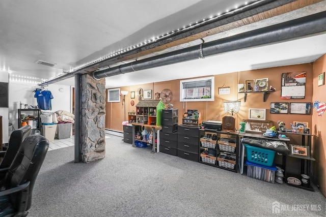 finished basement with carpet floors, visible vents, and baseboard heating