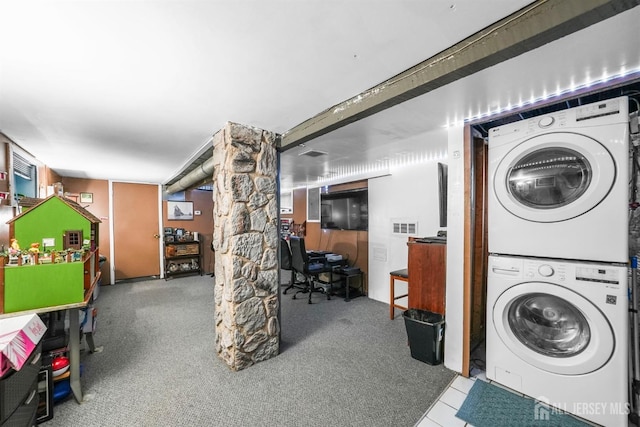 washroom featuring laundry area and stacked washing maching and dryer