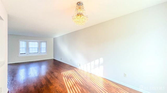 1204 Maplecrest Rd, Edison, NJ 08820 - unfurnished room with wood finished floors, a chandelier, and baseboards