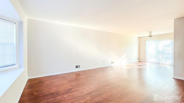 1204 Maplecrest Rd, Edison, NJ 08820 - spare room with wood finished floors, a chandelier, and baseboards