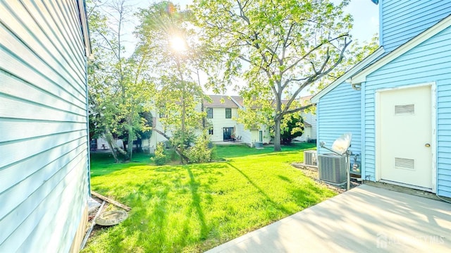 1204 Maplecrest Rd, Edison, NJ 08820 - view of grassy yard featuring central AC unit and a patio
