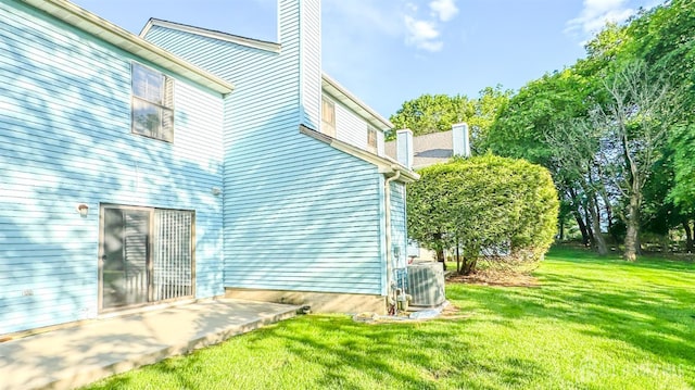 1204 Maplecrest Rd, Edison, NJ 08820 - view of property exterior with cooling unit, a lawn, a chimney, and a patio area