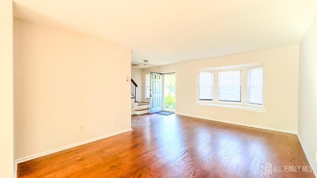 1204 Maplecrest Rd, Edison, NJ 08820 - empty room with stairway, wood finished floors, and baseboards