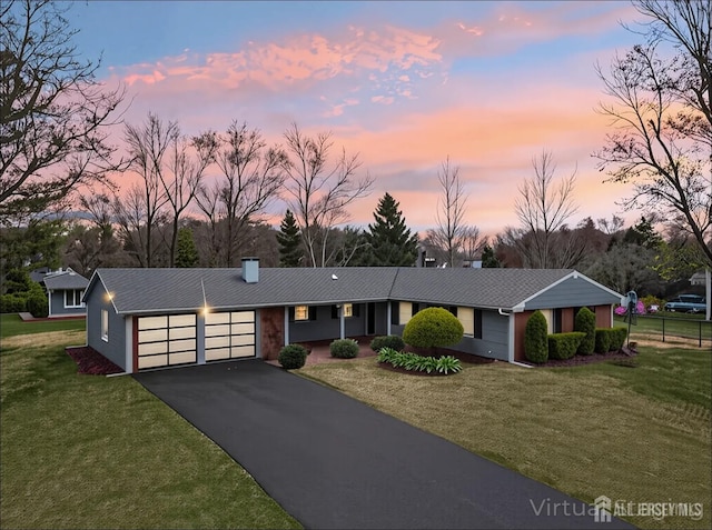 6 Macbeth Dr, Old Bridge, NJ 08857 - view of front of house with an attached garage, asphalt driveway, a front yard, and a chimney