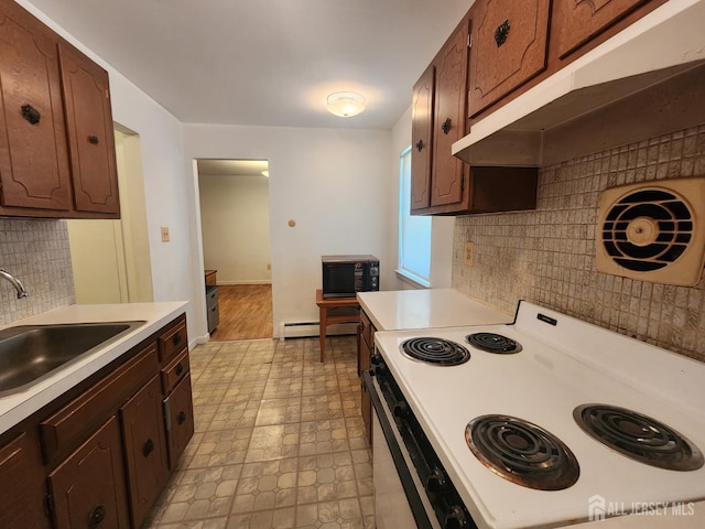 138 The Orchards Unit C, East Windsor, NJ 08512 - kitchen with white range with electric stovetop, under cabinet range hood, light countertops, black microwave, and decorative backsplash