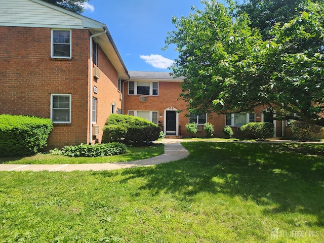 138 The Orchards Unit C, East Windsor, NJ 08512 - view of front of home with a front yard and brick siding