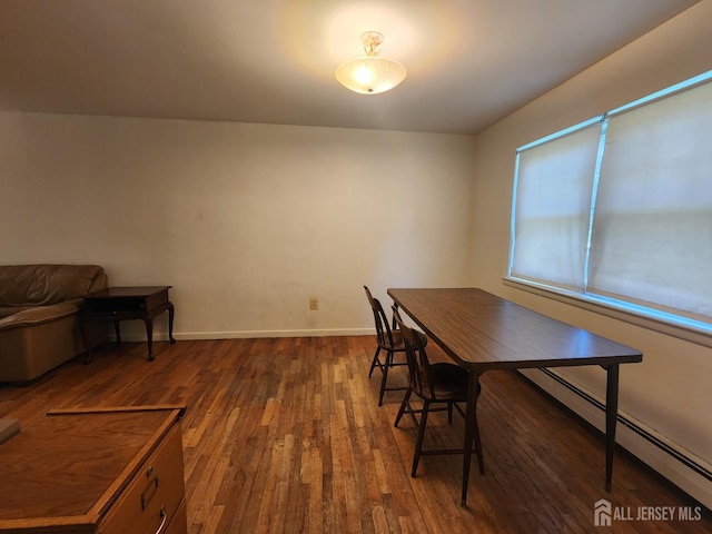 138 The Orchards Unit C, East Windsor, NJ 08512 - dining space featuring baseboard heating and dark wood-style flooring