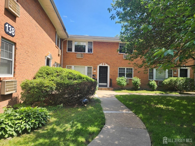 138 The Orchards Unit C, East Windsor, NJ 08512 - view of front facade featuring a front lawn and brick siding