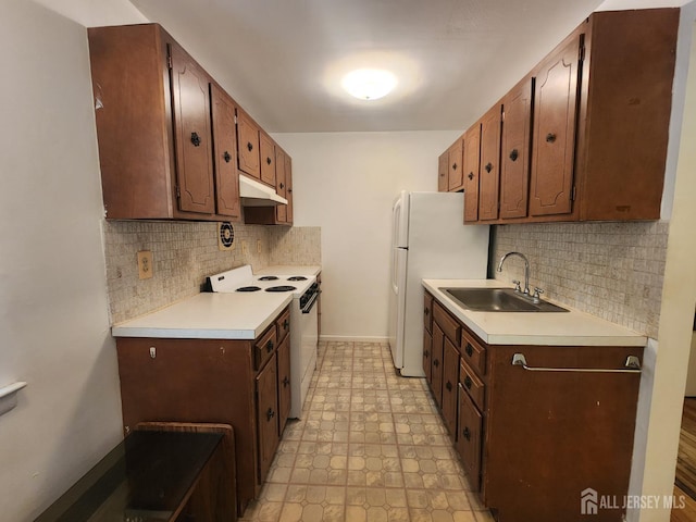 138 The Orchards Unit C, East Windsor, NJ 08512 - kitchen with white appliances, under cabinet range hood, decorative backsplash, and light countertops
