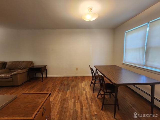 138 The Orchards Unit C, East Windsor, NJ 08512 - dining area featuring dark wood-style flooring and a baseboard heating unit