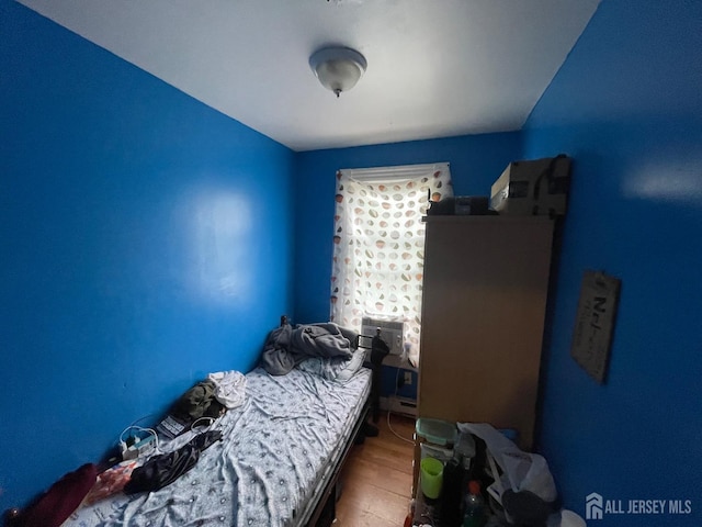 bedroom featuring wood finished floors