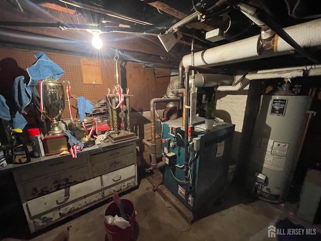unfinished below grade area with a heating unit and gas water heater