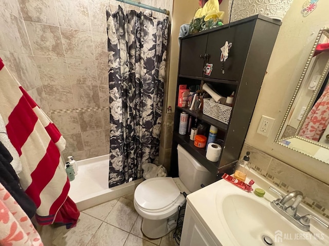 bathroom featuring a shower stall, tile patterned flooring, vanity, and toilet