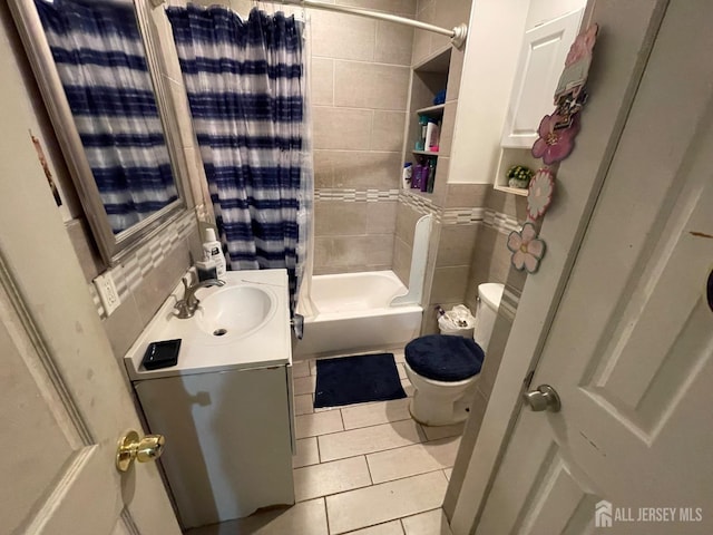 full bath with toilet, tile patterned flooring, vanity, and shower / bath combination with curtain
