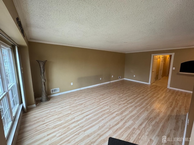 unfurnished living room with ornamental molding, a textured ceiling, and light wood-type flooring