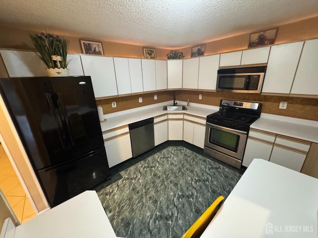 kitchen featuring white cabinetry, appliances with stainless steel finishes, and a textured ceiling