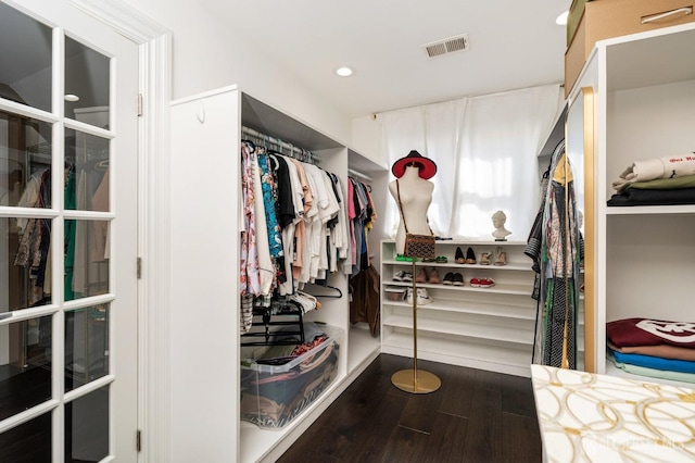 spacious closet featuring wood finished floors and visible vents