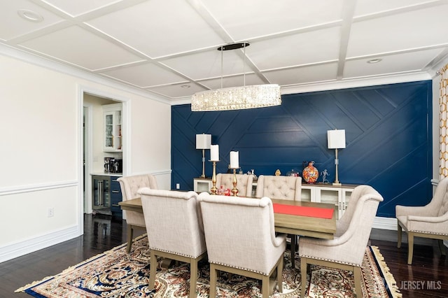 dining area featuring coffered ceiling, an inviting chandelier, and wood finished floors