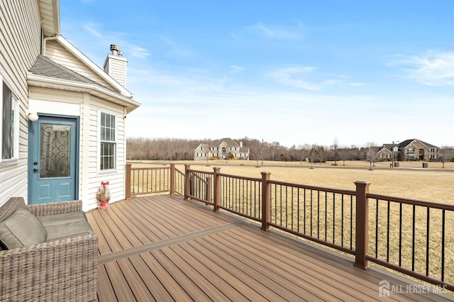 wooden terrace featuring a yard