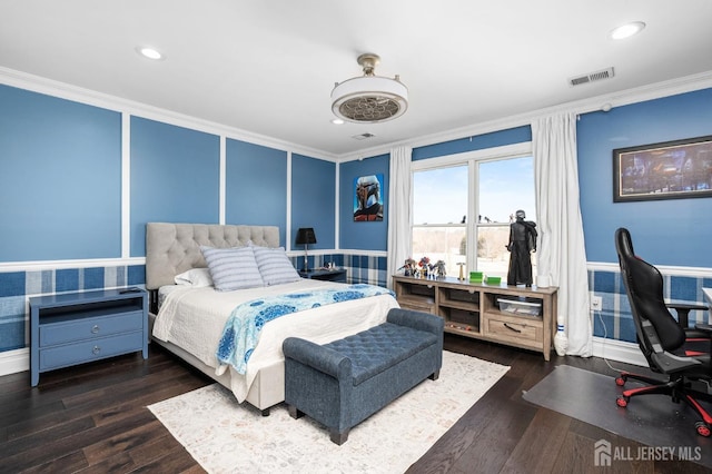 bedroom featuring visible vents, crown molding, recessed lighting, wood finished floors, and a decorative wall