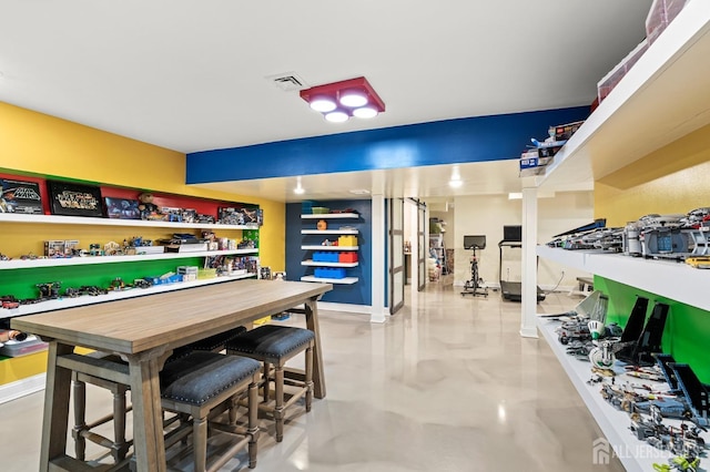 interior space with visible vents, finished concrete flooring, and baseboards