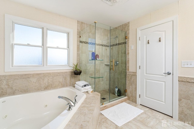 bathroom with a shower stall and a whirlpool tub