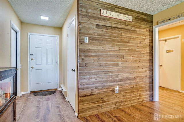 444 Dahlia Plz, Monroe, NJ 08831 - doorway to outside featuring a textured ceiling, wood finished floors, and wooden walls