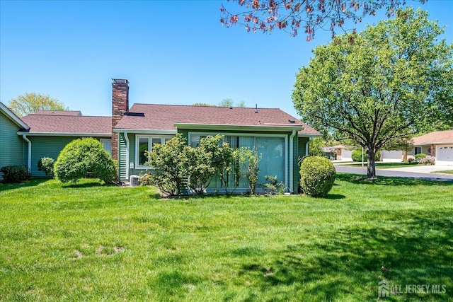 444 Dahlia Plz, Monroe, NJ 08831 - rear view of house featuring a chimney and a yard