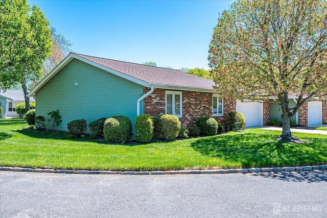 444 Dahlia Plz, Monroe, NJ 08831 - view of front of property featuring a front yard, an attached garage, concrete driveway, and brick siding