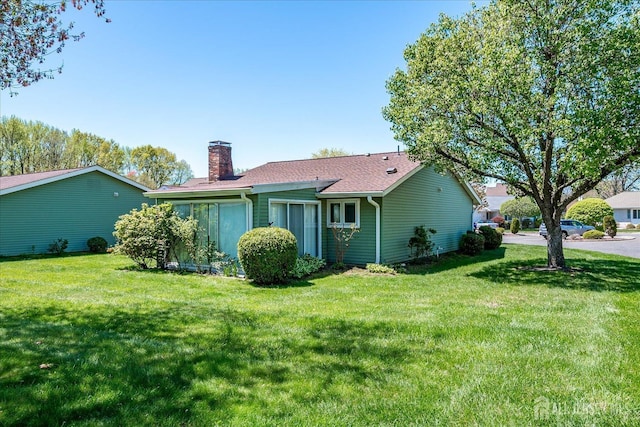 444 Dahlia Plz, Monroe, NJ 08831 - back of property featuring a chimney, a yard, and roof with shingles