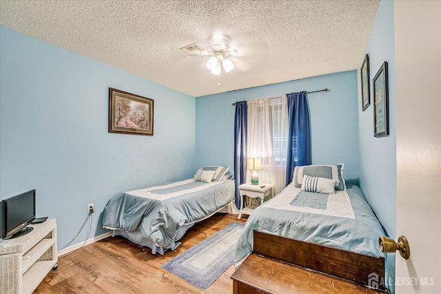 444 Dahlia Plz, Monroe, NJ 08831 - bedroom with wood finished floors, a textured ceiling, baseboards, and ceiling fan