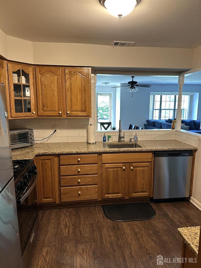 151 Wyndham Pl, Robbinsville, NJ 08691 - kitchen featuring stainless steel appliances, brown cabinets, dark wood-style flooring, and glass insert cabinets